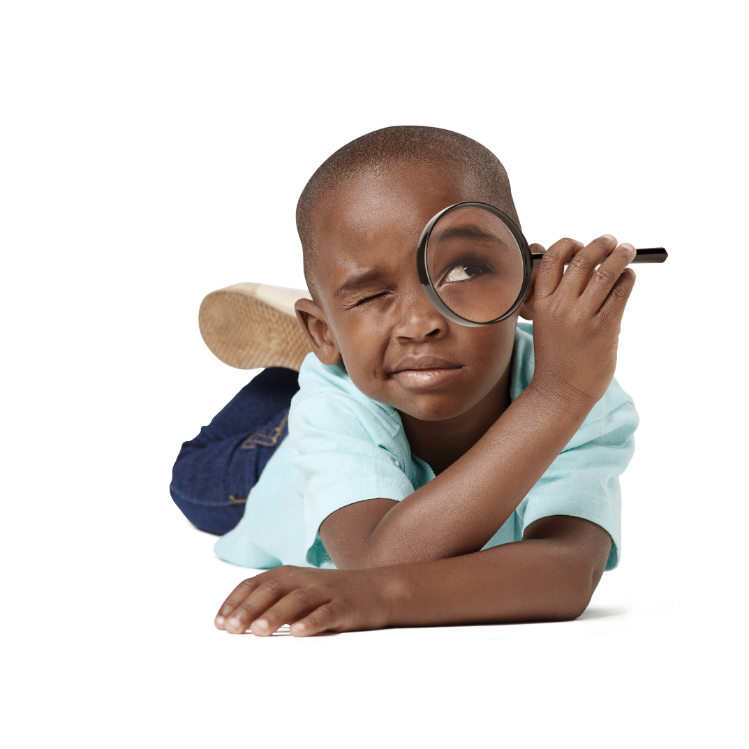 boy looking through magnifying glass